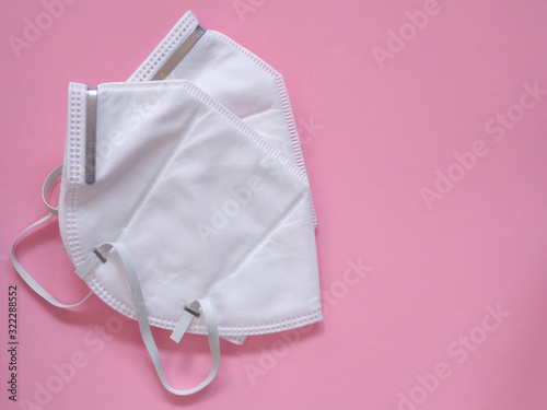 Protective face mask on pink background, Concept medical and health care, Top view.