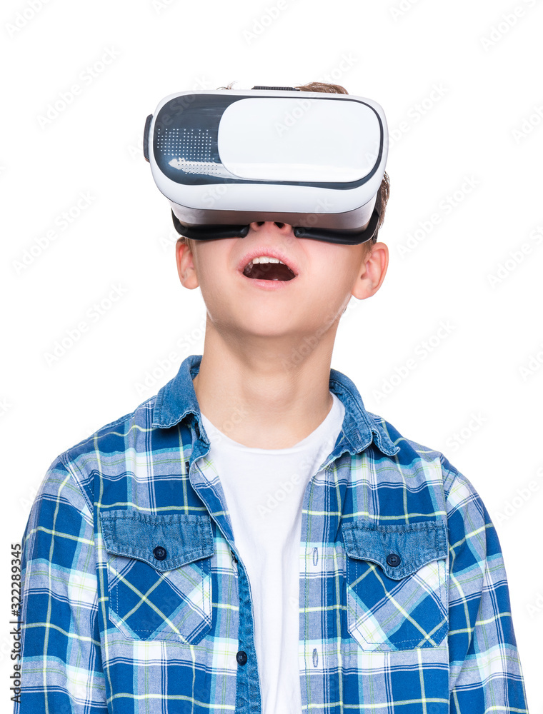 Happy teen boy wearing virtual reality goggles watching movies or playing video games, isolated on white. Cheerful teenager looking in VR glasses. Funny child experiencing 3D gadget technology. Happy teen boy wearing virtual reality goggles watching movies or playing video games, isolated on white. Cheerful teenager looking in VR glasses. Funny child experiencing 3D gadget technology.