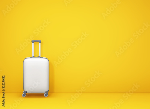 White suitcase on yellow background with copy space