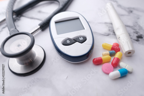 blood sugar measurement tools and stethoscope on table 