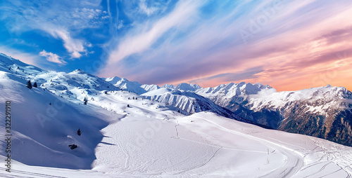 Beautiful Austrian Mountain Ski Resort Panorama Sunset, Pink Orange Sky And Ski Trails