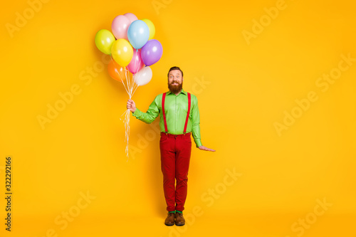 Full body photo of imposing man hold many balloons celebrate b-day event wear good look outfit isolated over vibrant color background