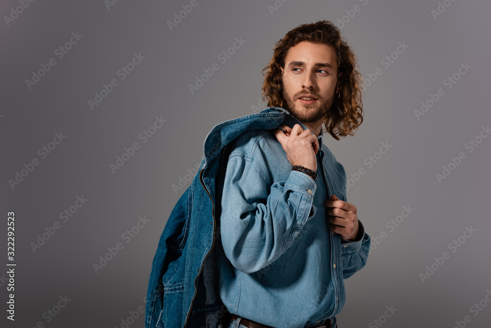 handsome and stylish man in denim shirt looking away isolated on grey handsome and stylish man in denim shirt looking away isolated on grey