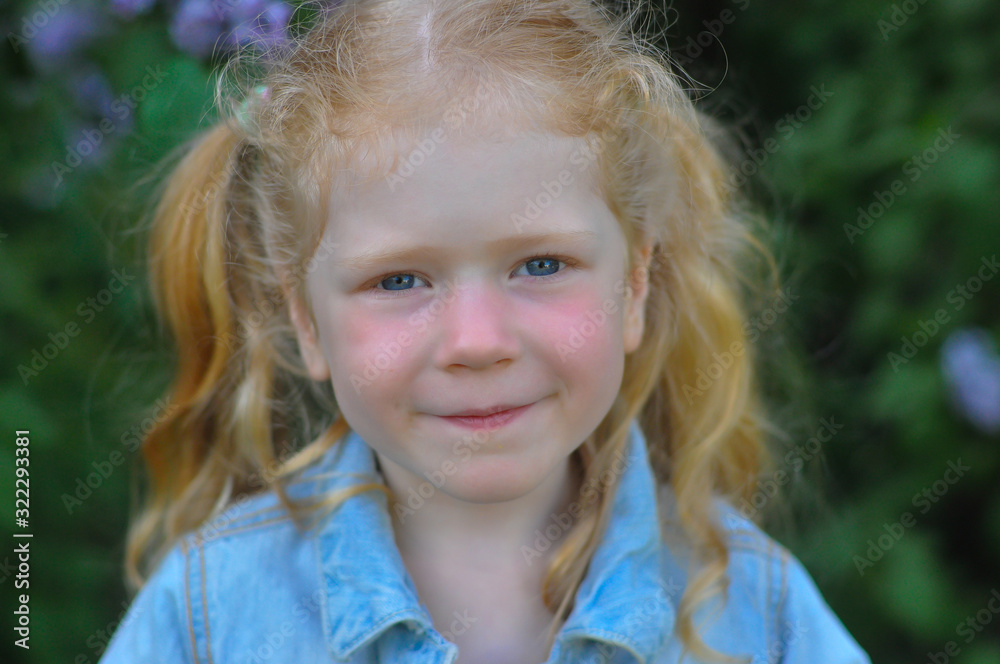 horizontal portrait of a little girl on the background of a blooming garden horizontal portrait of a little girl on the background of a blooming garden