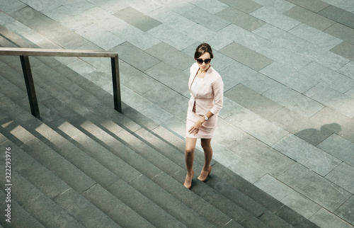 Young woman dressed in business style next to the stairs, business and career concept