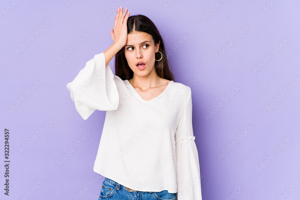 Young caucasian woman isolated on purple background being shocked, she has remembered important meeting. Young caucasian woman isolated on purple background being shocked, she has remembered important meeting.