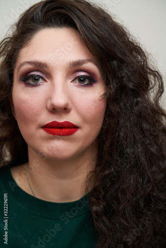 Portrait of young brunette with red lips