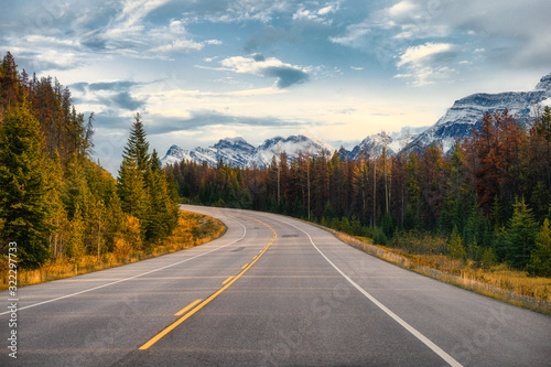 Scenic road trip with rocky mountain in autumn forest at Icefields Parkway