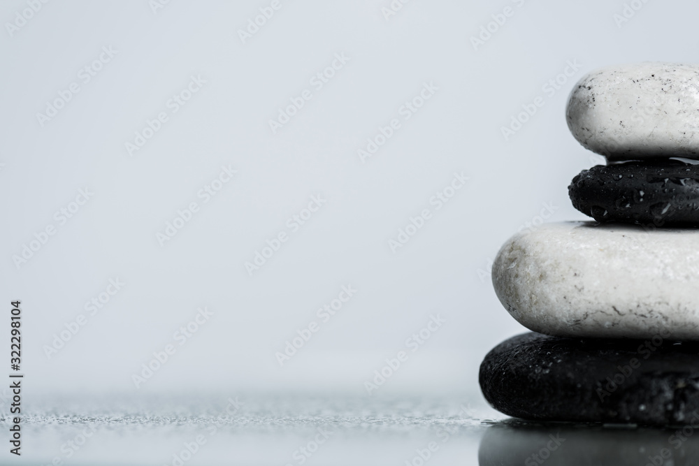 Close up view of water drops on zen stones on wet glass isolated on grey - obrazy, fototapety, plakaty 