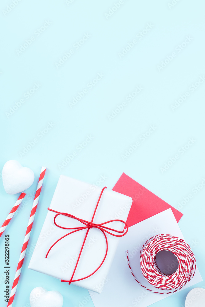 Valentine's Day, Mother's day handmade gift design concept - Wrapped gift box isolated on pastel light blue color background, flat lay, top view. Valentine's Day, Mother's day handmade gift design concept - Wrapped gift box isolated on pastel light blue color background, flat lay, top view.
