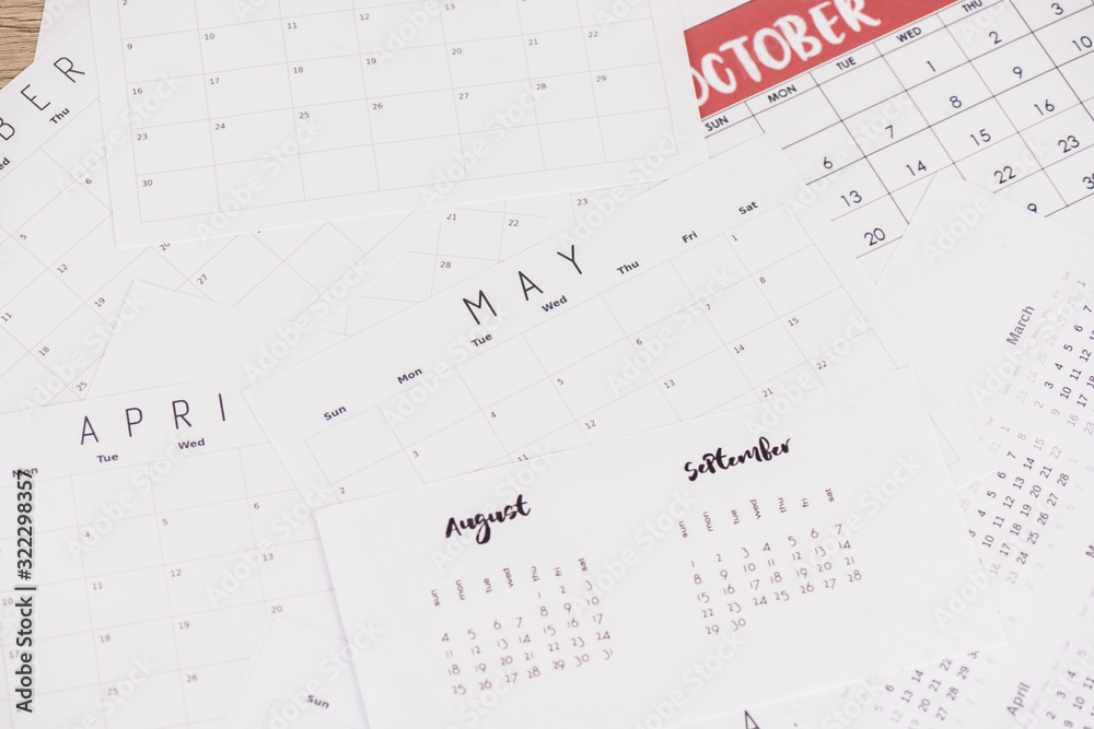 High angle view of calendars with mouths on wooden surface High angle view of calendars with mouths on wooden surface