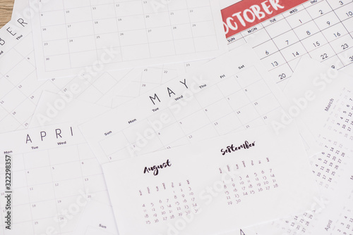 High angle view of calendars with mouths on wooden surface