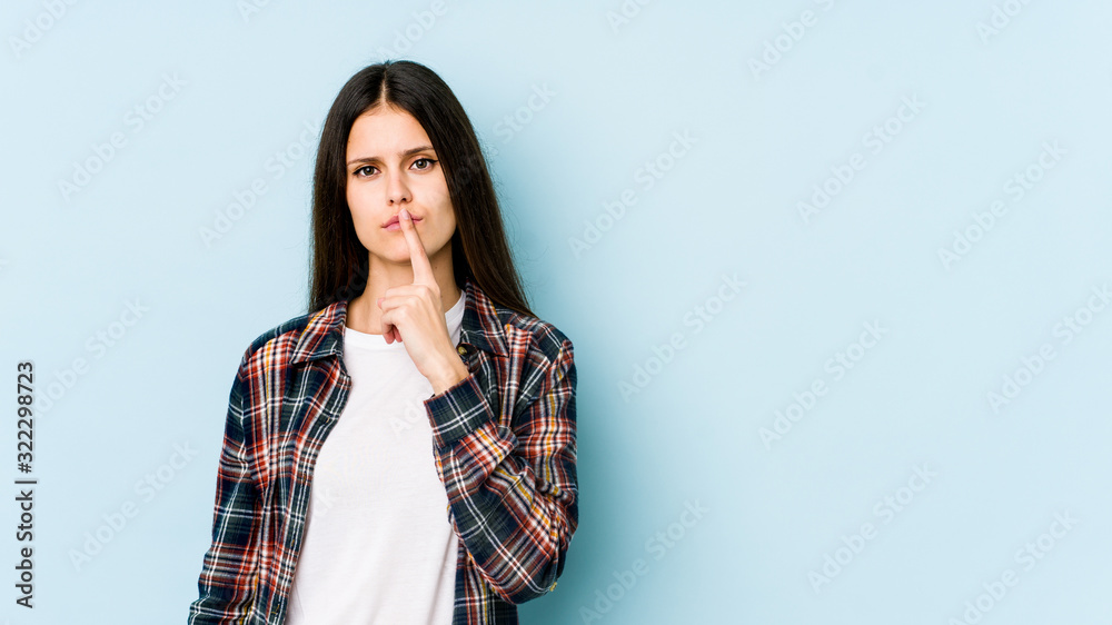 Young caucasian woman isolated on blue background thinking and looking up, being reflective, contemplating, having a fantasy. Young caucasian woman isolated on blue background thinking and looking up, being reflective, contemplating, having a fantasy.