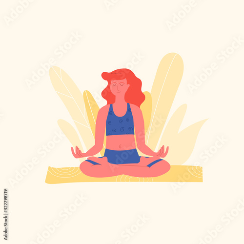 Red-haired woman is meditating in lotus pose or padmasana asana on yellow yoga mat. Yoga, stretching, pilates instructor. Physical activity as a way to relieve stress. Physical and mental health.