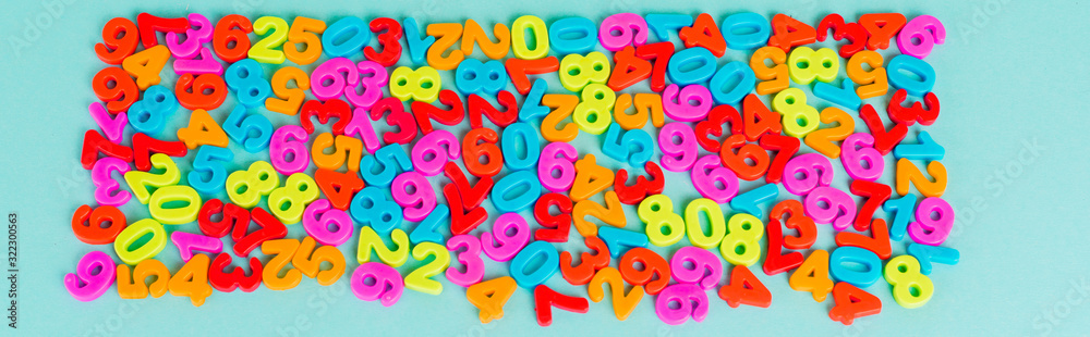 Top view of colorful numbers on blue background, panoramic shot Top view of colorful numbers on blue background, panoramic shot