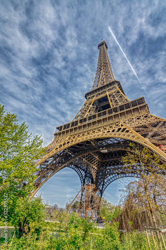 PARIS, Ile-de-France, FRANCE - APRIL 15 2019: Vertical view of isolated Eiffel Tower with beautiful blue sky