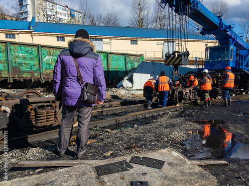 Train accident. Railway workers liquidate the emergency. Damaged train cars after the train went off the rails.