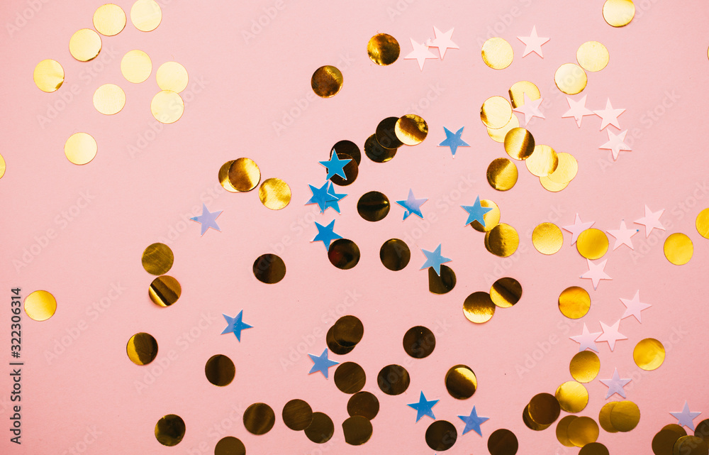 Golden confetti on pink pastel trendy background. Golden confetti on pink pastel trendy background.