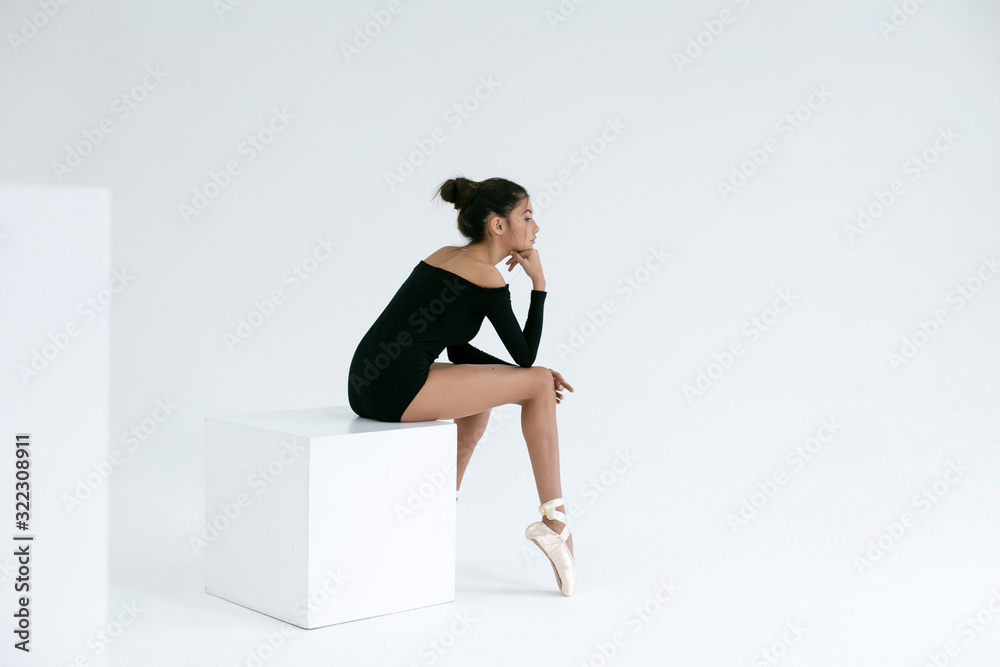 horizontal photo of a ballerina in a black leotard on a white background horizontal photo of a ballerina in a black leotard on a white background