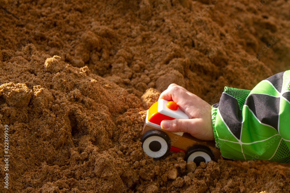 Boy playing with a machine in the sand. Boy playing with a machine in the sand.