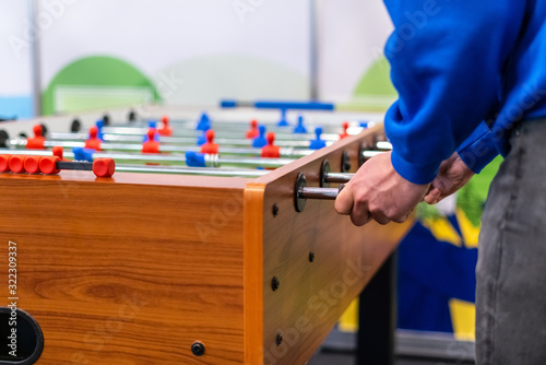 People playing foosball table soccer. Team sport, table football players. Competitive table game photo