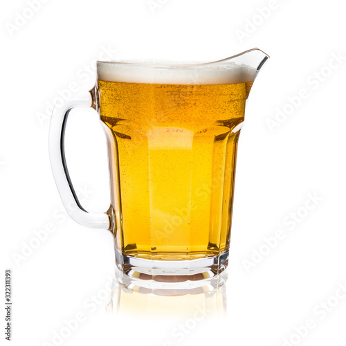 Cuadro en lienzo Glass jug of light beer with foam isolated on white background.