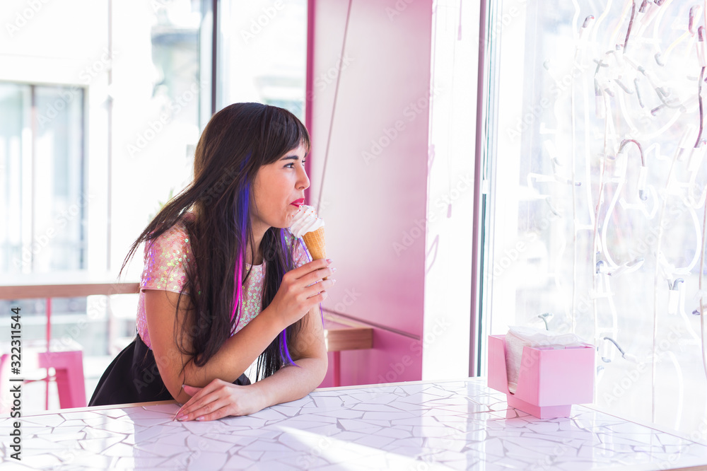 Summer, youth and dessert concept - Pretty girl enjoying an ice-cream cone in cafe Summer, youth and dessert concept - Pretty girl enjoying an ice-cream cone in cafe