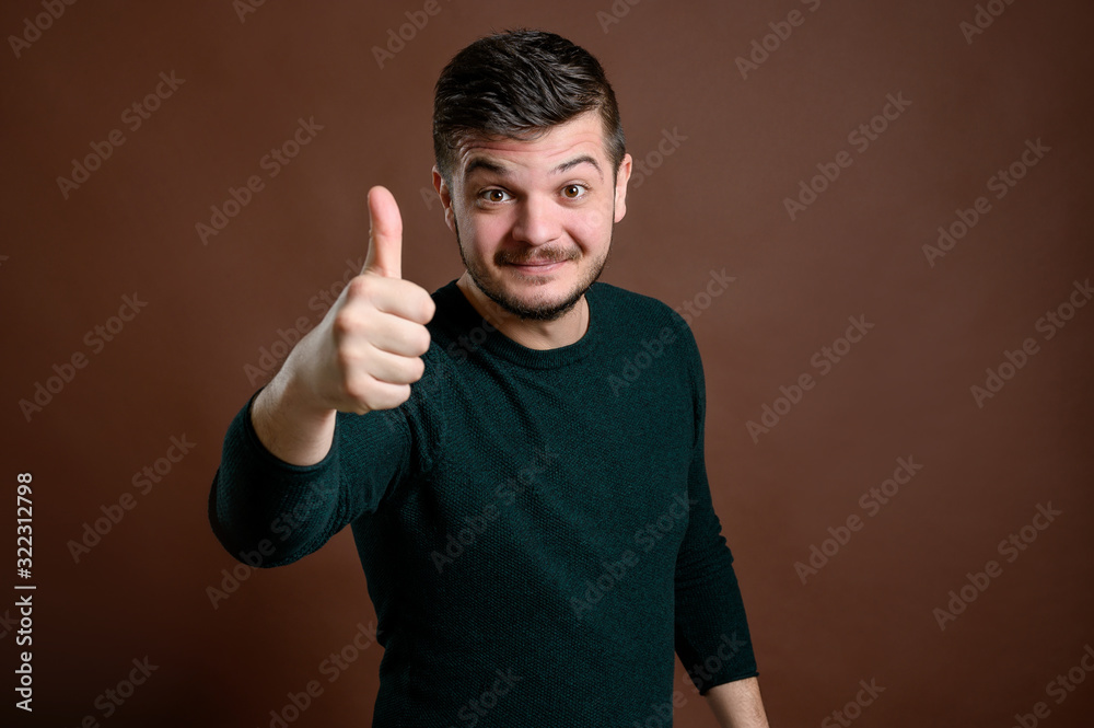 Young man showing thumbs up Young man showing thumbs up