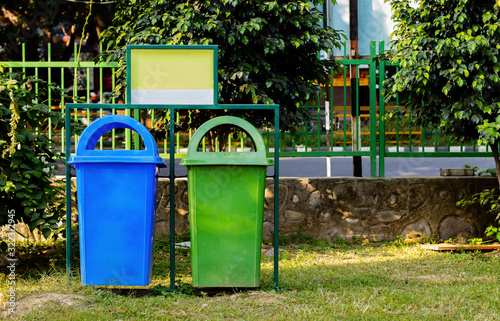 paper and plastic recycle bin placed in the garden for cleanness. cleanness concept