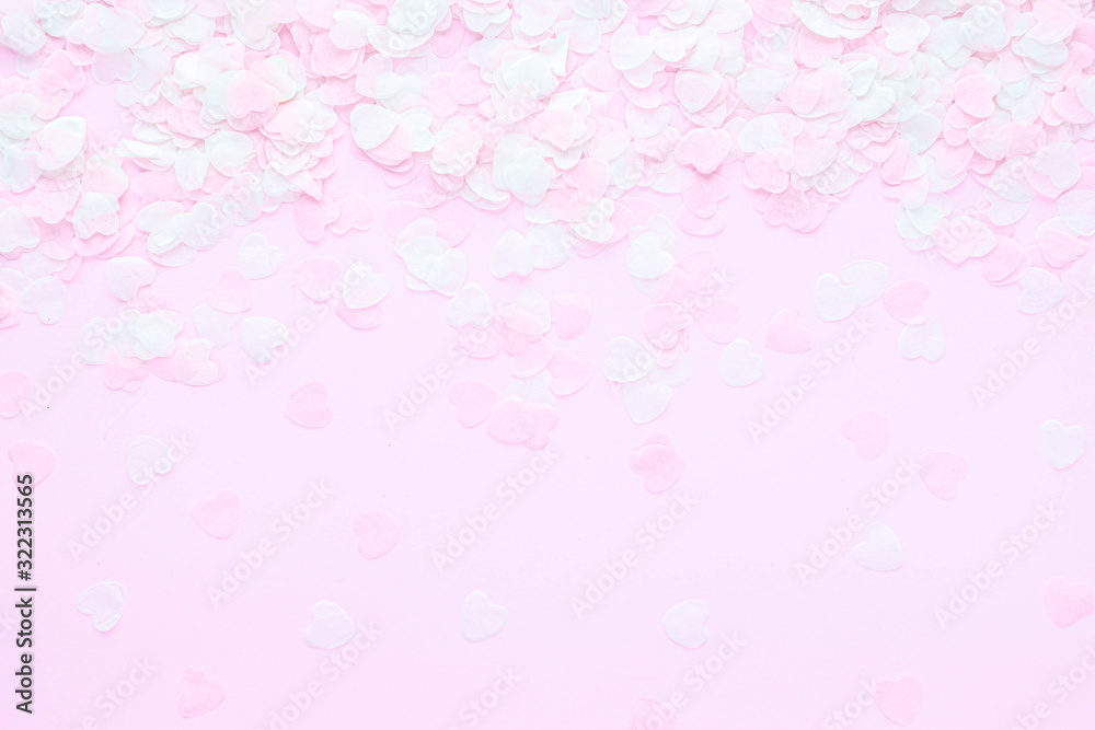 Heart made of pink confetti on pastel background. Festive romantic gentle abstract background for the design. Valentine's Day. Top view, flat lay composition. Copy space for text. Heart made of pink confetti on pastel background. Festive romantic gentle abstract background for the design. Valentine's Day. Top view, flat lay composition. Copy space for text.