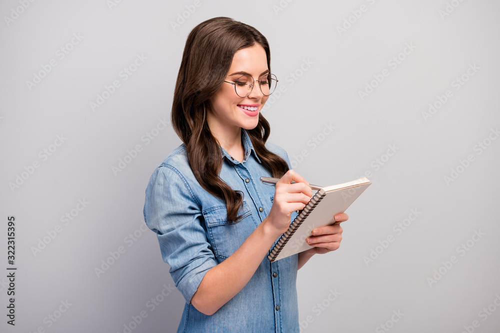 Profile photo of beautiful student lady hold personal planner noting lecture learn study information wear specs casual jeans denim shirt isolated grey color background Profile photo of beautiful student lady hold personal planner noting lecture learn study information wear specs casual jeans denim shirt isolated grey color background