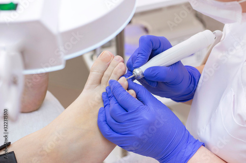 Therapeutic pedicure. Master podologist does hardware pedicure. visit to the podiatry. Foot treatment in the spa. Clinic of Podiatria.