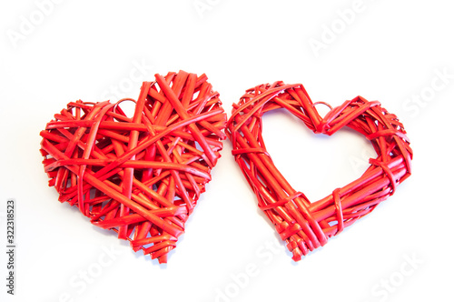 Two big red wicker hearts. On white background. Love