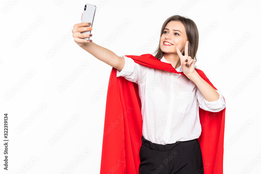 Superhero Woman. Young and beautiful woman in red cout take selfie on the phone isolated on white background Superhero Woman. Young and beautiful woman in red cout take selfie on the phone isolated on white background