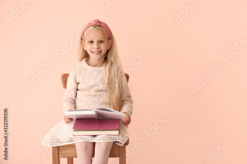 Little girl reading book on...