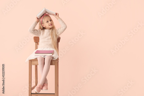 Little girl with books on c...