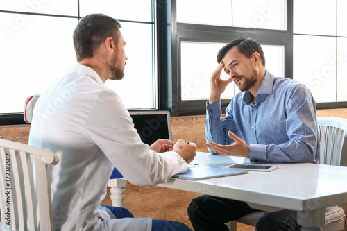 Patient visiting doctor in modern clinic