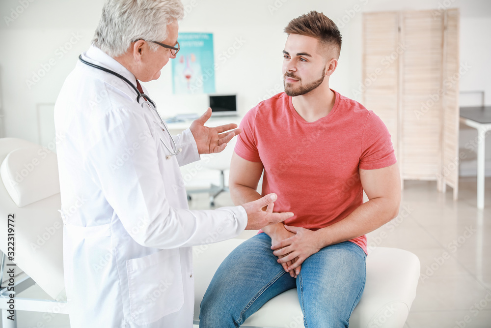 Young man visiting urologist in clinic Young man visiting urologist in clinic