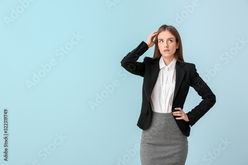 Thoughtful businesswoman on color background. Concept of choice