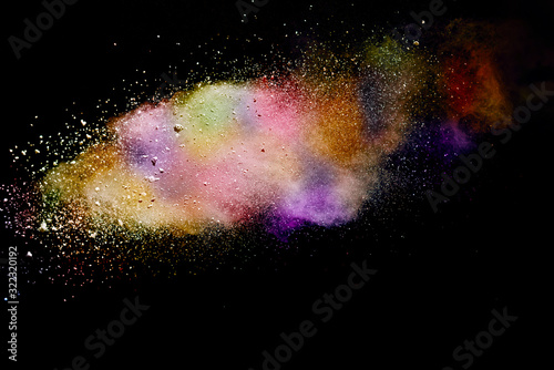 Abstract powder splatted background. Colorful powder explosion on black background. Colored cloud. Colorful dust explode. Paint Holi.