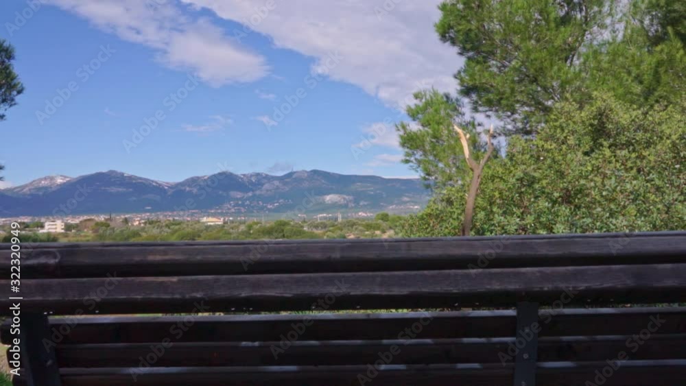 Slide shot of Parnitha mountain, with a wooden bench in the foreground 60fps Slide shot of Parnitha mountain, with a wooden bench in the foreground 60fps