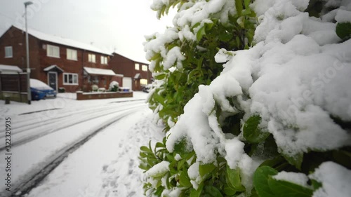 Heavy snow hits Stoke on Trent in the West Midlands after a storm suddenly appears, blanketing the city in ice and snow, snowy blizzard photo