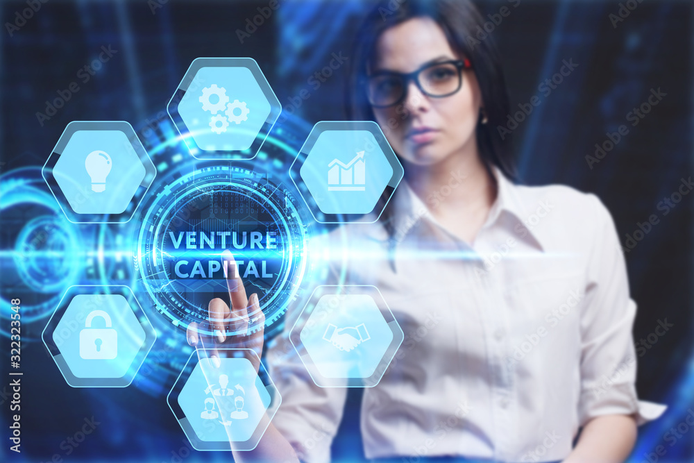Business, Technology, Internet and network concept. Young businessman working on a virtual screen of the future and sees the inscription: Venture capital Business, Technology, Internet and network concept. Young businessman working on a virtual screen of the future and sees the inscription: Venture capital