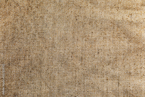 Texture of coarse burlap fabric. Beige canvas with large threads. Solid rough rural jute background. Top view.