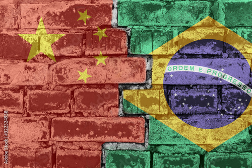 China and Brazil flag against a brick wall