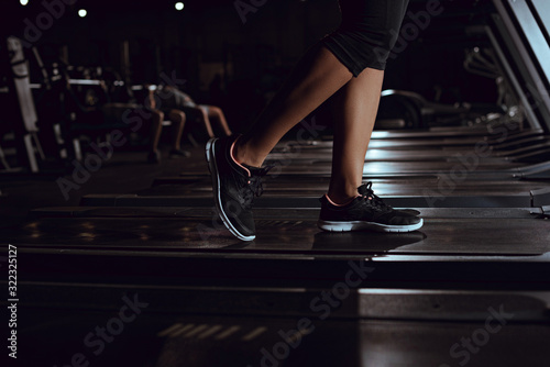 Cropped view of african american woman wearing sneakers on treadmill © LIGHTFIELD STUDIOS