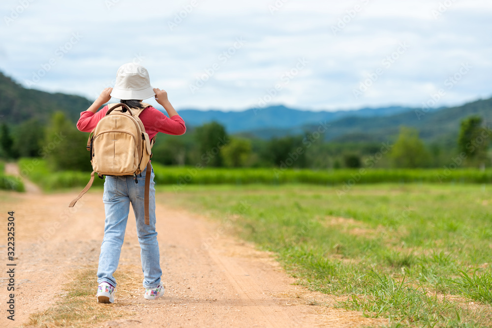 Children travel nature summer trips. Asia people tourism walking on nature road happy and fun explore adventure outdoors for leisure and destination, mountain background. Travel Lifestyle Concept