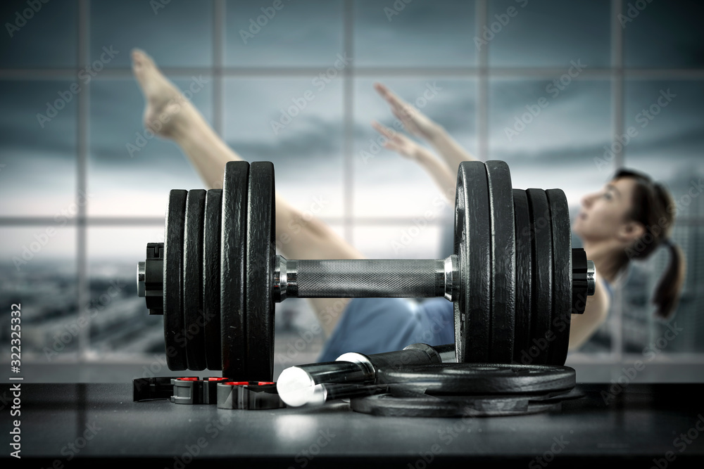 Slim young woman and gym interior 