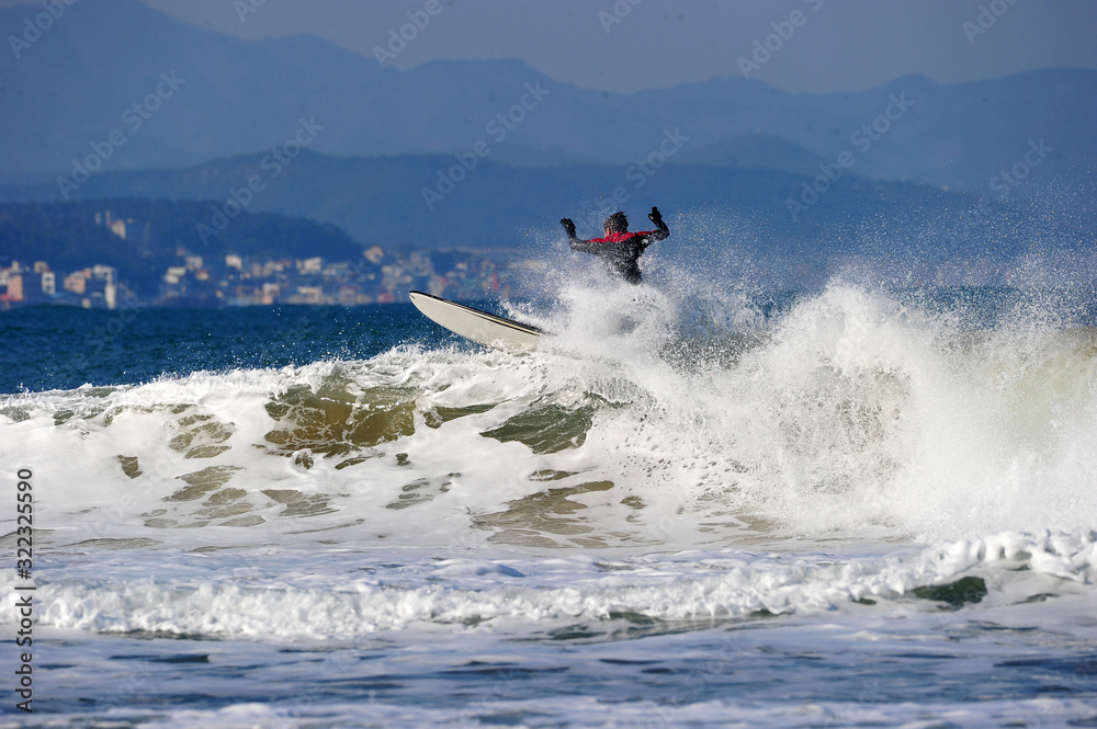 Naklejka premium Koreans Enjoy Surfing on Feb. 9, 2020 at the Yonghan-ri Beach in Heunghae-eup, Pohansi, South Korea.