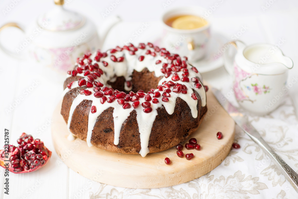 chocolate cake with pomegranate on a white table, a cozy breakfast, English tea party, chocolate dessert, a delicious cake with pomegranate, a photo of sweet food with free space for text chocolate cake with pomegranate on a white table, a cozy breakfast, English tea party, chocolate dessert, a delicious cake with pomegranate, a photo of sweet food with free space for text